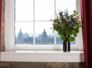 Window sill with flowers with views of South Edinburgh