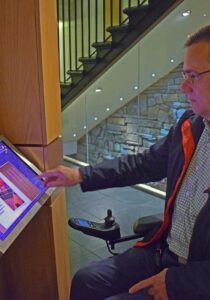 Touchscreen being used by a wheelchair user at The Scotch Whisky Experience.