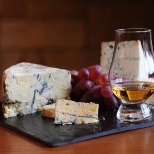 Amber cheese platter with dram and grapes
