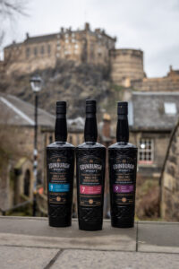 Edinburgh Whisky bottles with Edinburgh Castle backdrop.