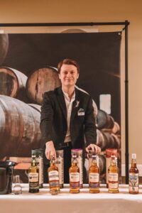 Cody Reynolds, Angus Dundee Distillers with bottles of whisky.
