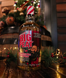 A bottle of Big Peat Christmas Edition in a festive scene
