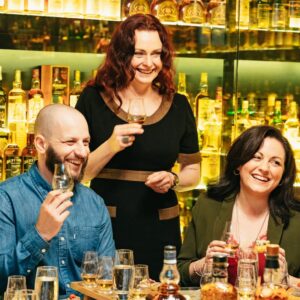 Guide and couple enjoying a whisky tasting in the whisky collection.