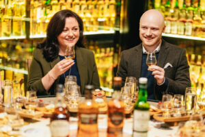 Male and female enjoying a whisky tasting.