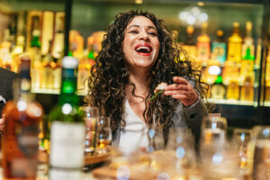 Female with canape during whisky tasting.