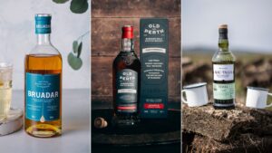 Bottle of Bruadar whisky, Old Perth whisky with box, Mac-Talla whisky with two white mugs on peat
