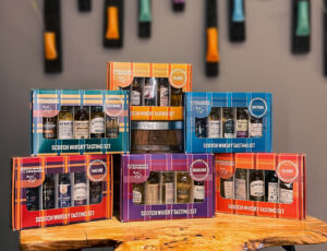 Packs of colourful Scotch whisky miniatures on a wooden table