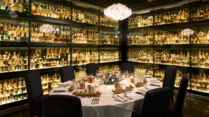 Table set within the Whisky Collection with floor to ceiling bottles of whisky.