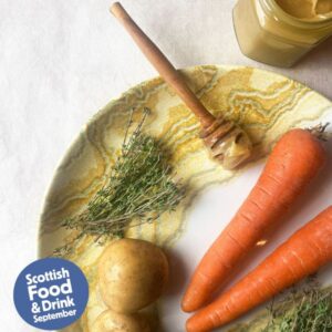 Image of plate with carrots, honey, potatoes and Scottish Food and Drink logo