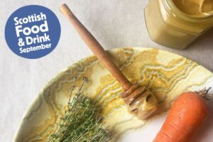 Image of plate with carrot, honey, thyme and Scotland Food and Drink logo