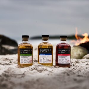 Elixir Distillers whiskies on a beach