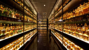 A collection of 3,384 unsealed Scotch whiskies in glass cabinets.