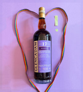 Bottle of Glencadam whisky against a purple background with rainbow laces and an exclamation mark.