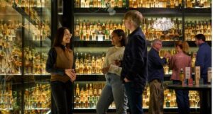 Tour guide and visitors within one of the world's largest collections of Scotch whisky at The Scotch Whisky Experience
