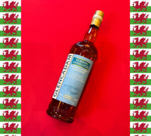Bottle of Glencadam Andalucia on a red background with a border of Welsh flags.